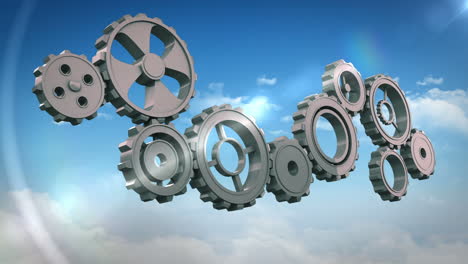Cogs-and-wheels-turning-against-blue-sky