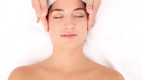 Attractive-young-woman-receiving-head-massage-at-spa-center