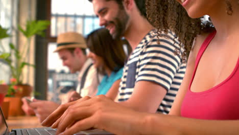 Hipsters-using-their-laptops-in-cafe