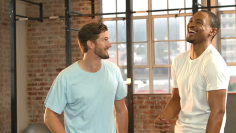 Fit-people-smiling-together-in-crossfit-gym