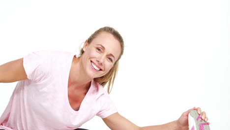 Smiling-fit-woman-stretching-with-hands-to-feet