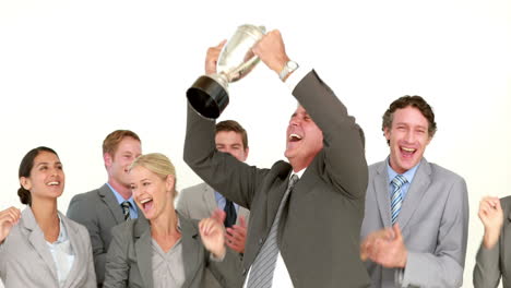 Businessman-holding-cup-and-cheering-with-his-colleagues-