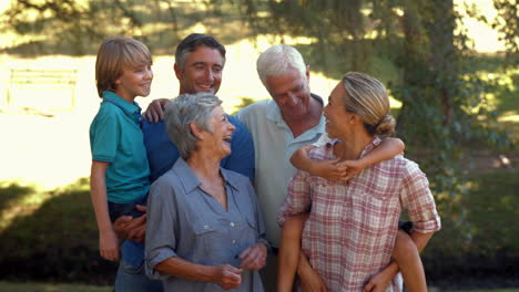 Happy-family-smiling-at-the-camera-in-the-park