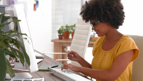 Creative-businesswoman-typing-on-computer