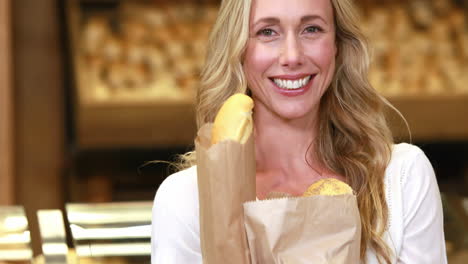 Smiling-blonde-holding-paper-bags