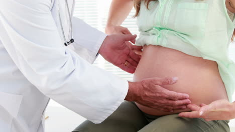 Pregnant-woman-being-checked-by-a-doctor