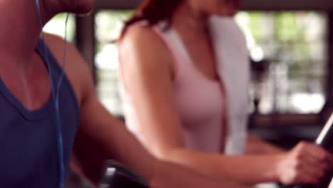 Fit-people-doing-exercise-with-elliptical-machine