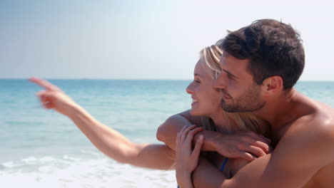 Happy-cute-couple-hugging-at-the-beach-