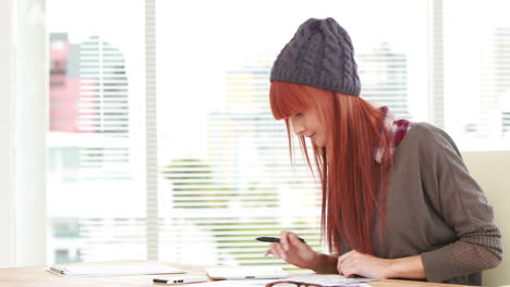 Red-haired-hipster-using-a-tablet