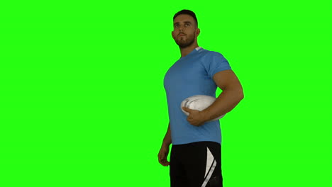 Serious-rugby-player-holding-ball