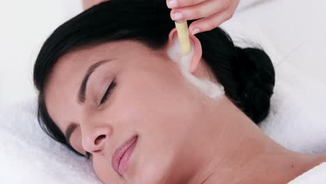 Woman-getting-ear-candling-treatment