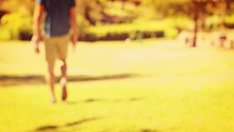 Close-up-of-man-holding-retro-photo-camera-in-the-park