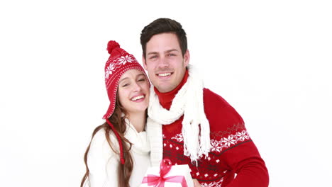 Smiling-woman-offering-gift-to-boyfriend