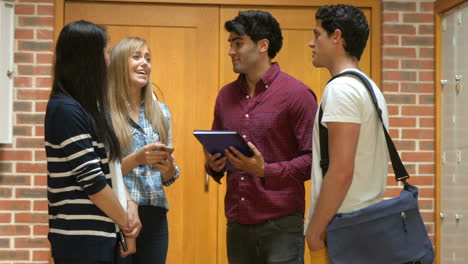 Smiling-students-discussing-in-hallway