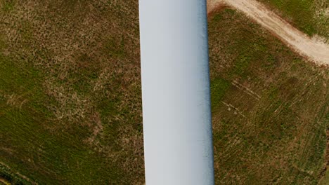 Wind-Turbine-Propeller-Blade-with-Close-Up-Aerial-Drone-Inspection-Dolly-Shot-and-Grass-Background