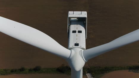 Wind-Turbine-Propeller-Blades-Close-Up-of-Nacelle-with-Aerial-Drone-TIlt-Down-Shot