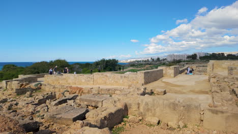 An-open-view-of-the-Tombs-of-the-Kings-in-Pafos,-showcasing-the-extensive-stone-ruins-and-pathways