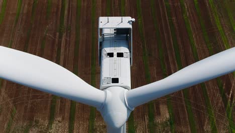 Wind-Turbine-Overhead-Shot-for-Inspection-from-an-Aerial-Drone-Ascending-with-Tilt-Down-Views