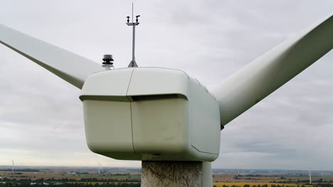 Wind-Turbine-Nacelle-from-Behind-Using-an-Aerial-Drone-for-Inspection,-Close-Up-Shot-Panning-Around