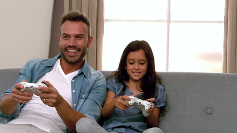 Happy-father-and-daughter-playing-video-games