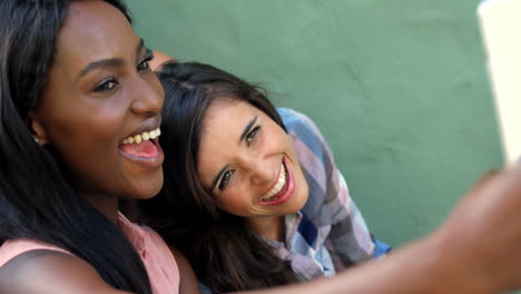 Portrait-of-attractive-girls-are-taking-a-selfie