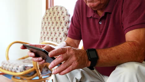 Senior-man-playing-with-tablet-pad