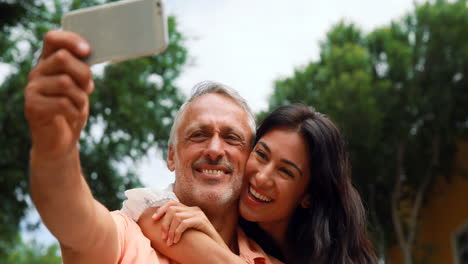 Smiling-couple-taking-selfie-