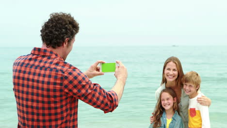 Father-taking-a-picture-of-her-family