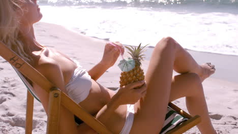 A-woman-is-enjoying-with-a-pineapple-cocktail-