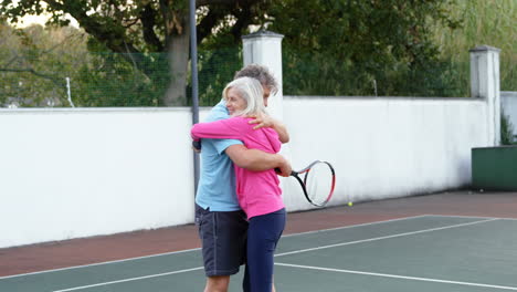 Senior-couple-hugging-on-tennis-court-4k