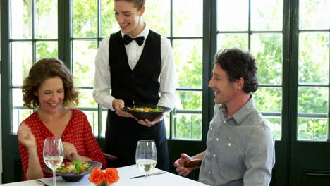 Cute-couple-is-being-waited-on-a-glass-during-lunch-meeting