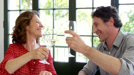 -Couple-toasting-wine-glasses-in-a-restaurant