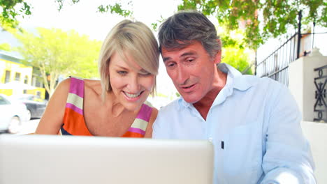 Smiling-couple-using-laptop