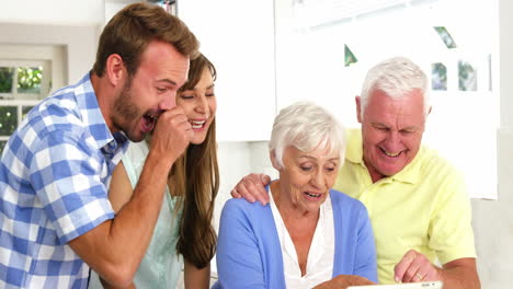 Happy-family-laughing-in-front-of-a-tablet