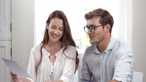 Cute-couple-working-together-on-laptop