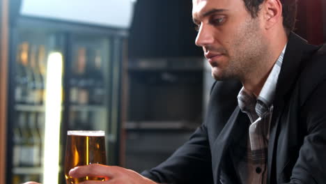 Anxious-businessman-drinking-beer-