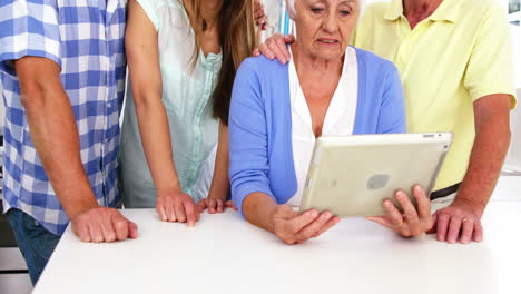 Happy-family-looking-tablet-together-