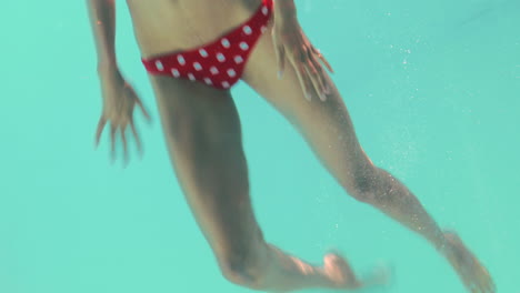 Smiling-woman-swimming-underwater