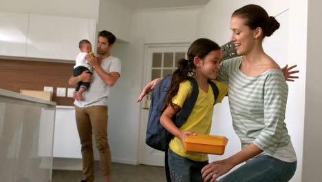 Child-ready-to-school-in-the-kitchen-with-family