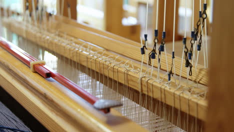 Close-up-of-hand-loom-machine-in-a-empty-workshop-4k