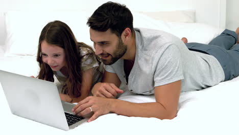 Father-and-daughter-using-laptop