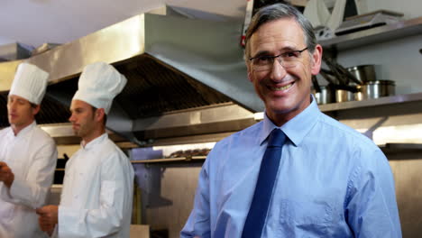 Employer-standing-in-the-restaurant-kitchen