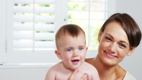 Portrait-of-a-happy-mother-with-her-smiling-baby