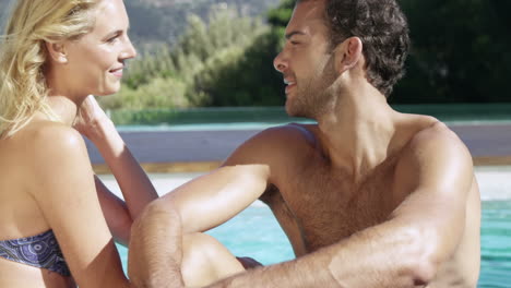 Attractive-couple-relaxing-by-the-pool