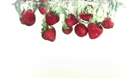 Red-strawberries-falling-into-water-in-super-slow-motion