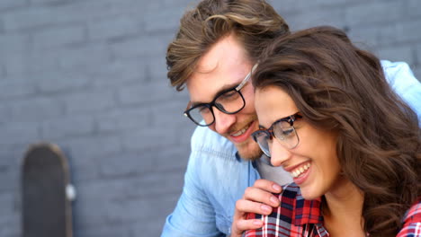 Friends-looking-at-smartphone-and-smiling