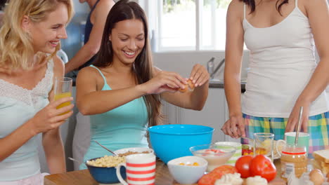 Smiling-friends-preparing-breakfast-