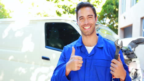 Repairman-with-tools-and-thumbs-up