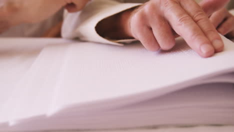 Senior-blind-man-reading-a-braille-book