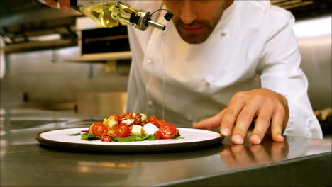 Chef-putting-oil-on-a-salad